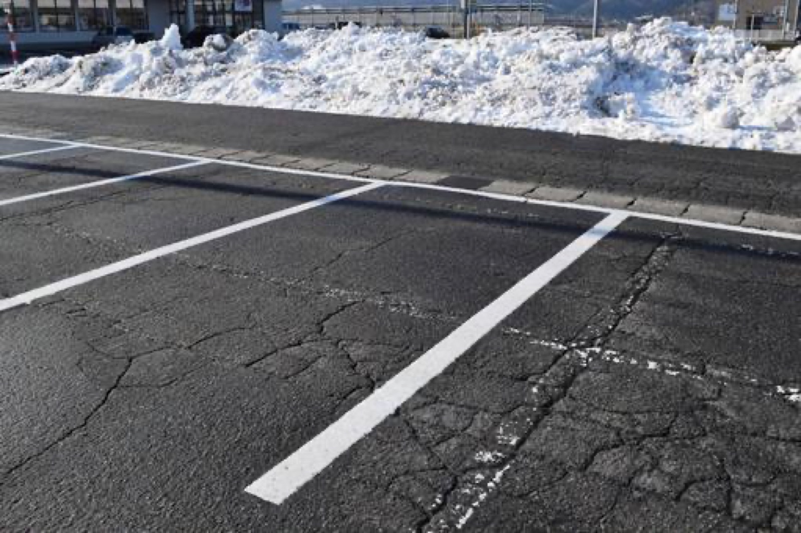 Parking lot with plowed snow bank